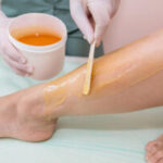 shugaring-concept-beautician-removes-hair-from-client-s-legs-with-sugar-paste-300x200